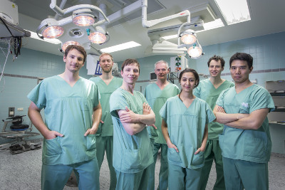 A group of researchers pose for a picture in the operating
           room